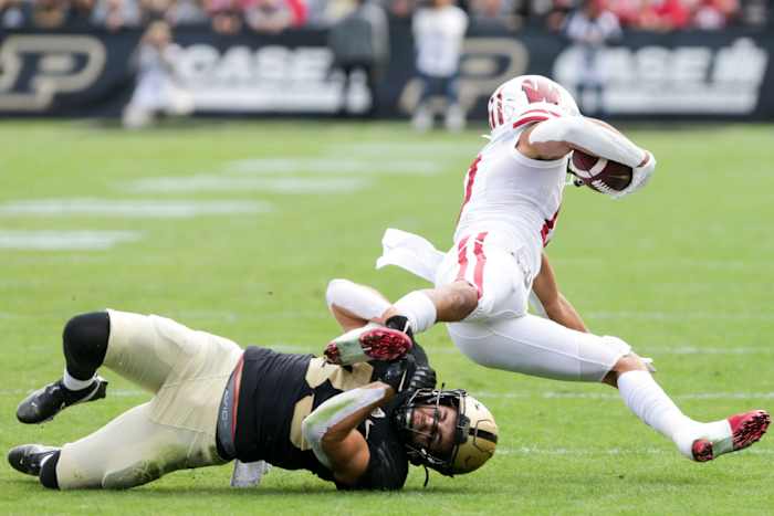Wisconsin wide receiver Chimere Dike tackled by a Purdue defender